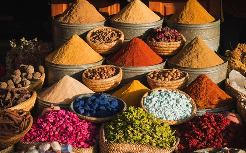 Bunte Gewürze auf einem traditionellen Marktstand in der Medina von Marrakesch, Marokko.