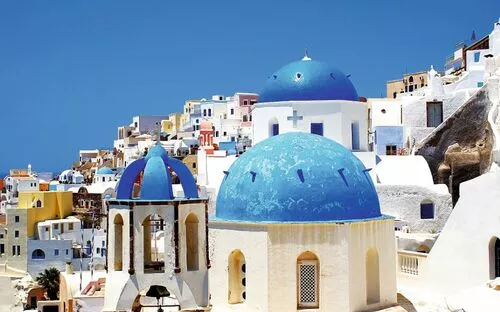 Blaue Kuppeln und weiße Gebäude in Santorini, Griechenland.