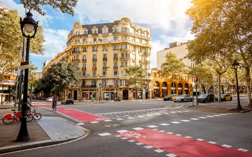 Städtische Straßenecke mit historischem Gebäude und Fahrradweg.
