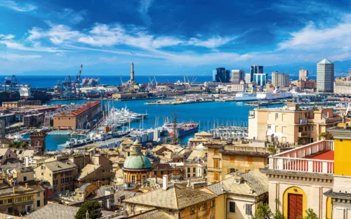 Küstenpanorama mit Hafen und Gebäuden bei sonnigem Wetter.