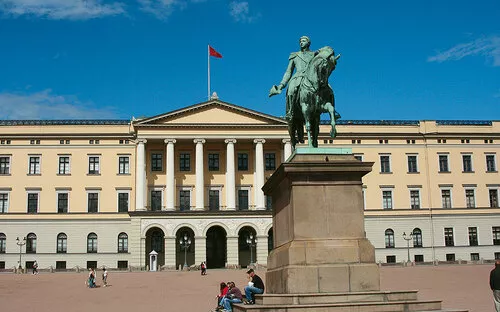 Das Bild zeigt das königliche Schloss in Oslo mit einer Reiterstatue im Vordergrund.