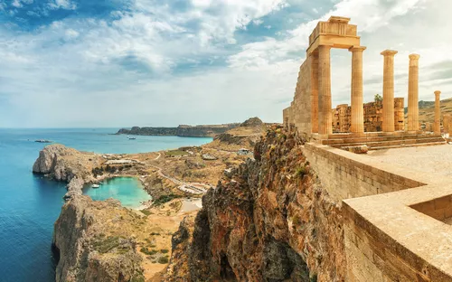 Alte Ruinen auf einer Klippe mit Meerblick im Hintergrund.