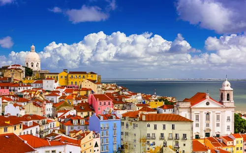 Stadtansicht von Lissabon mit bunten Häusern und Kirchen im Hintergrund.