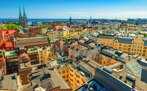 Stadtansicht mit bunten Gebäuden und blauem Himmel.