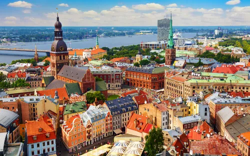 Stadtansicht mit historischen Gebäuden und Fluss im Hintergrund.
